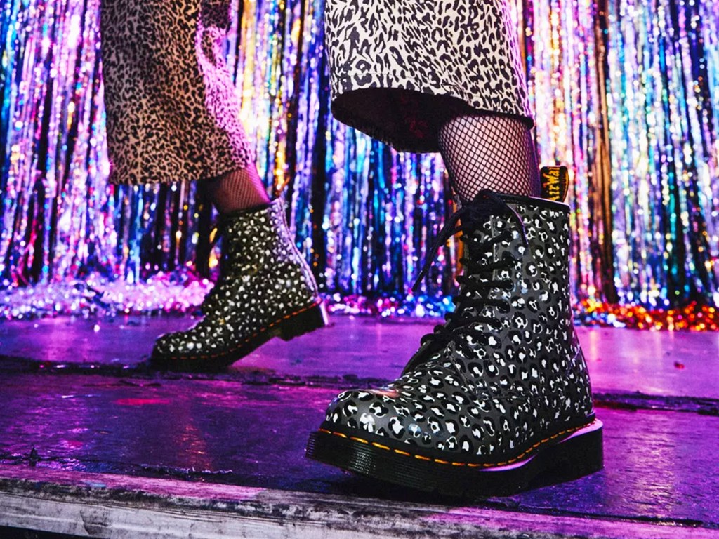 woman wearing grey leopard print boots