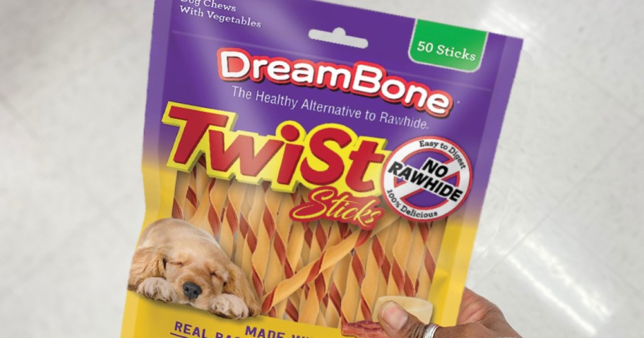 hand holding a bag of DreamBone Bacon & Cheese Twist Sticks