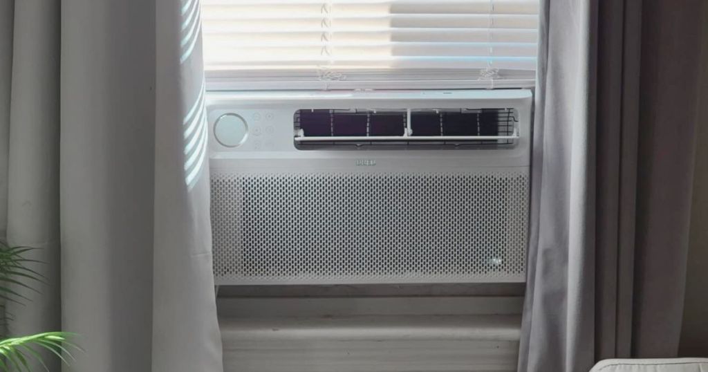 white Dreo air conditioner in window with curtains on each side