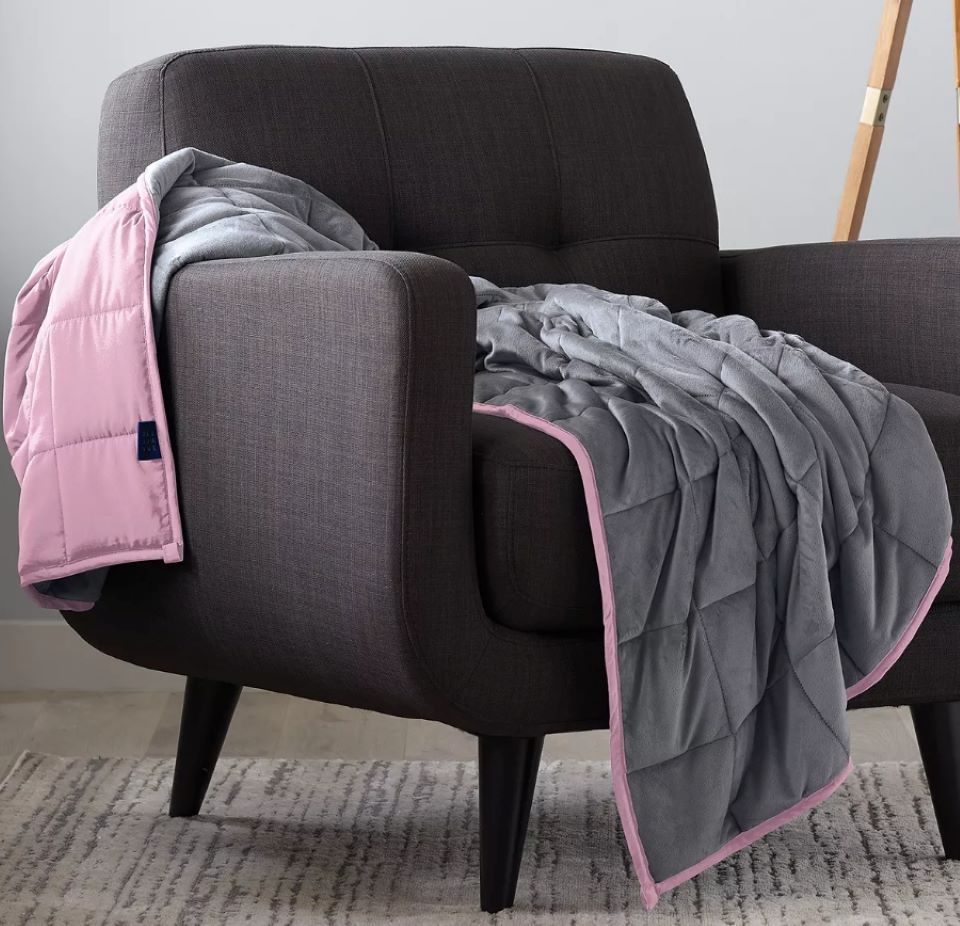 A grey and pink blanket on a chair