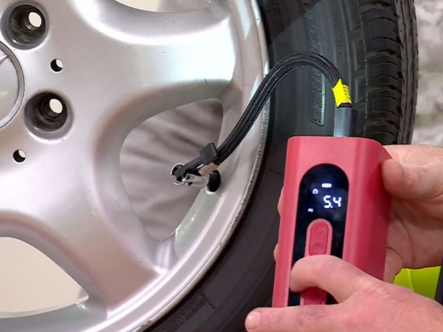 A tire being inflated using an energizer portable air compressor