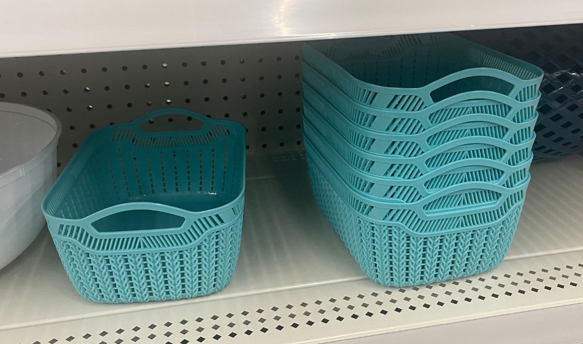 aqua colored small rectuangular storage baskets stacked on a store sheldf