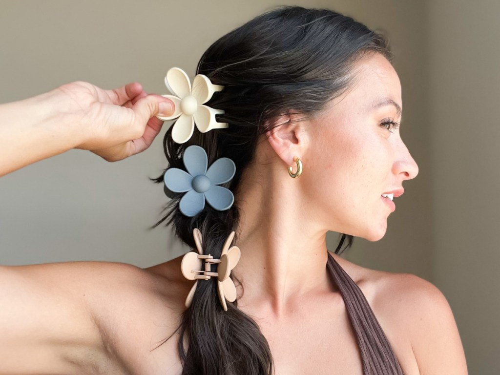 woman wearing 3 flower clips in long brown hair