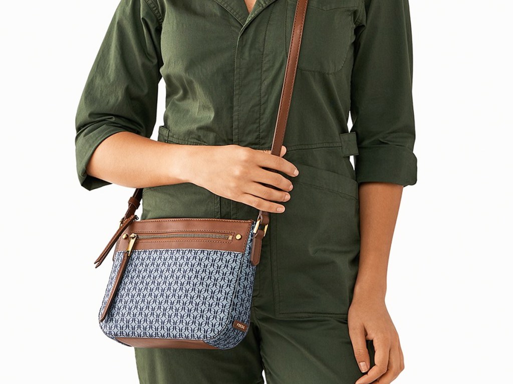 woman in green jumpsuit with blue and brown crossbody bag