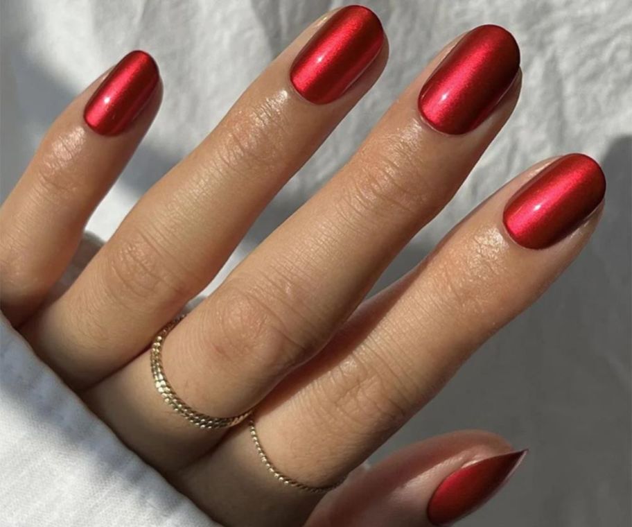A hand showing Glamnetic Cherry Glaze nails 