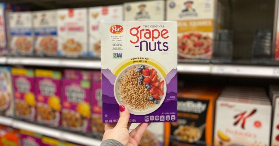 hand holding a box of Grape Nuts Cereal 20.5 oz