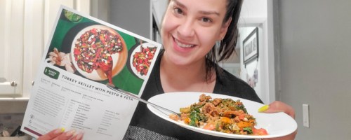 woman holding Green Chef meal and recipe card