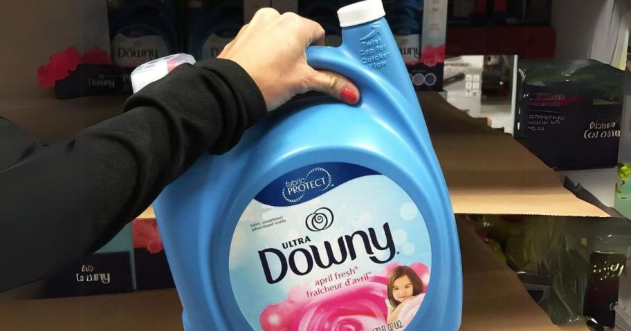 hand holding a huge bottle of Downy Ultra Liquid Fabric Softener