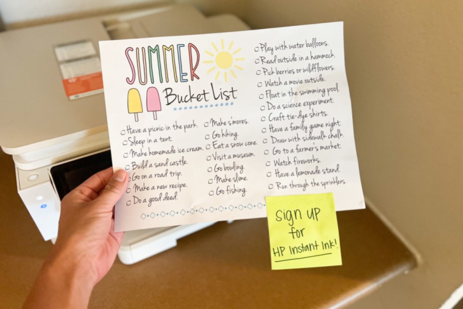 hand holding summer bucket list printable