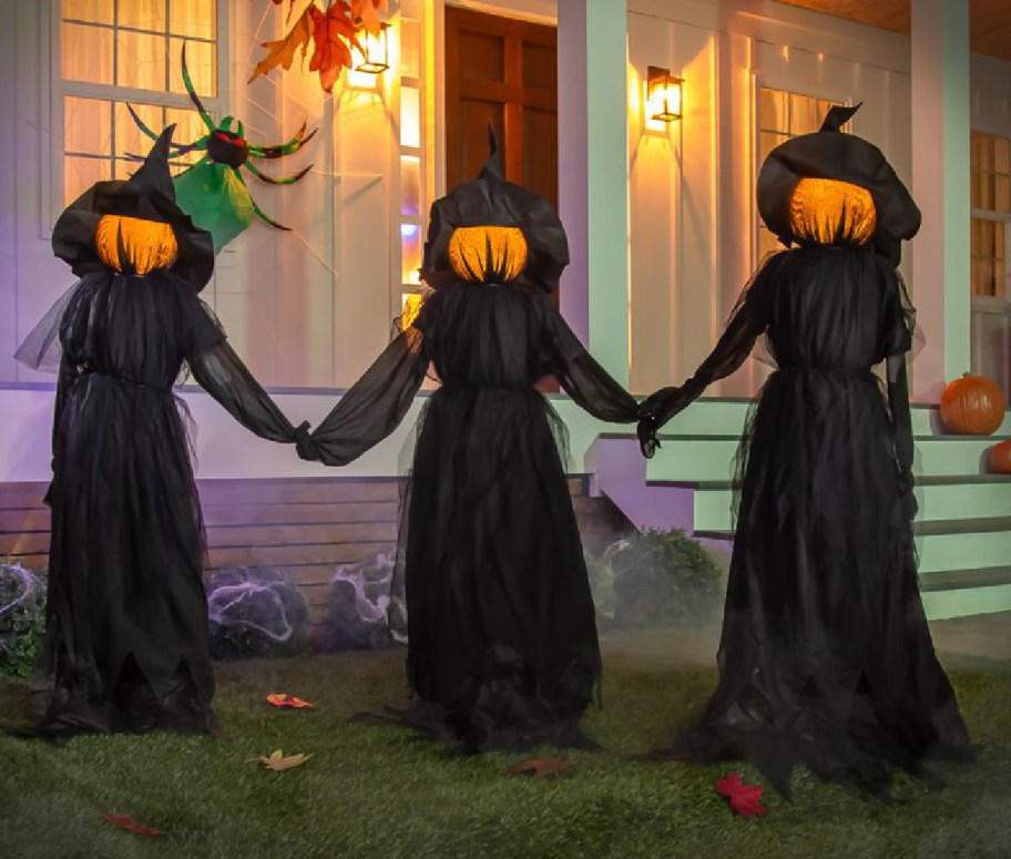Halloween witches displayed in the year holding hands