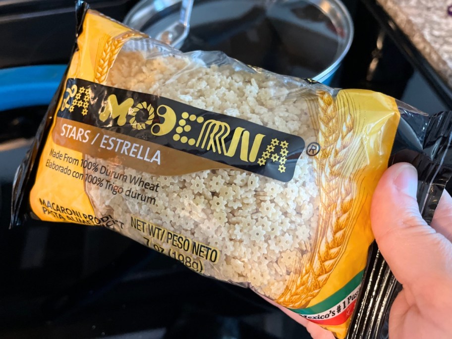Hand holding a bag of La Moderna Pasta Stars