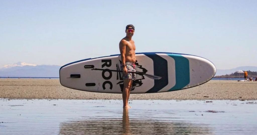 man in the water with a Roc Inflatable Paddle Board