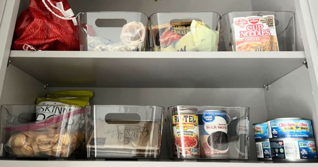 DDG Plastic Refrigerator Organizer Bins 8-Pack shown with food items in them inside a pantry cabinet