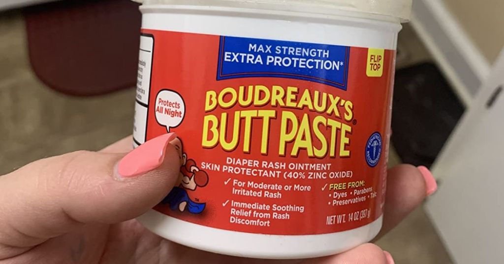 Boudreaux's Butt Paste Max. Strength Diaper Rash Cream 14 oz Jar in woman's hand