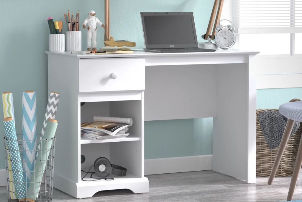 Campbell Wood Kids Desk with 1 Drawer and 2 Shelf Storage in white with laptop and desk accessories in a bedroom