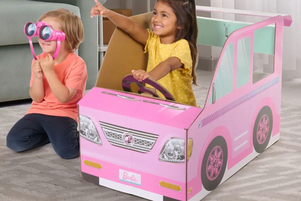 Two kids playing in a Pop2Play Barbie Camper