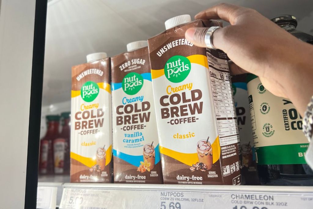 Nutpods Cold Brew Coffees in refrigerator aisle at Target with woman's hand grabbing 1