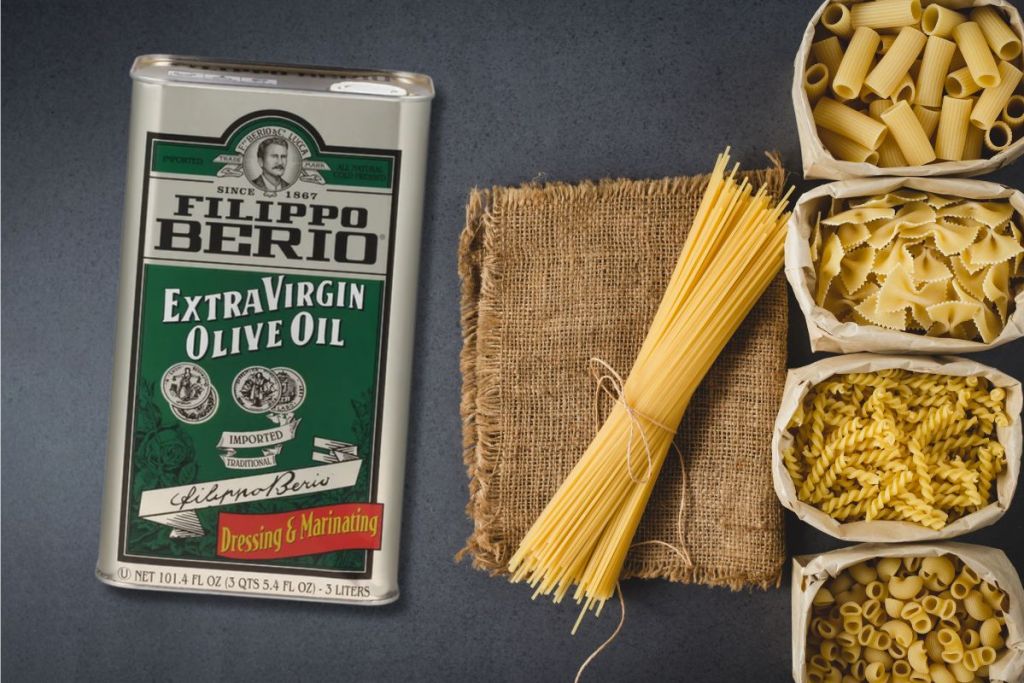 Filippo Berio Extra Virgin Olive Oil 101.4oz Tin shown with pasta