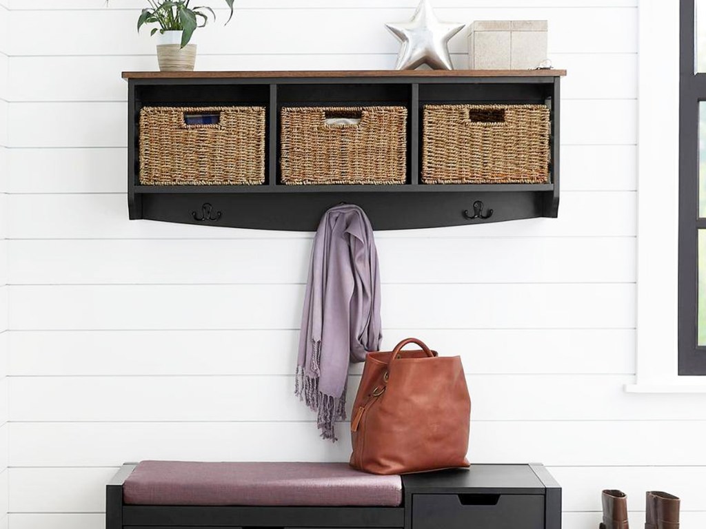 black cubby shelf on wall with 3 baskets on it