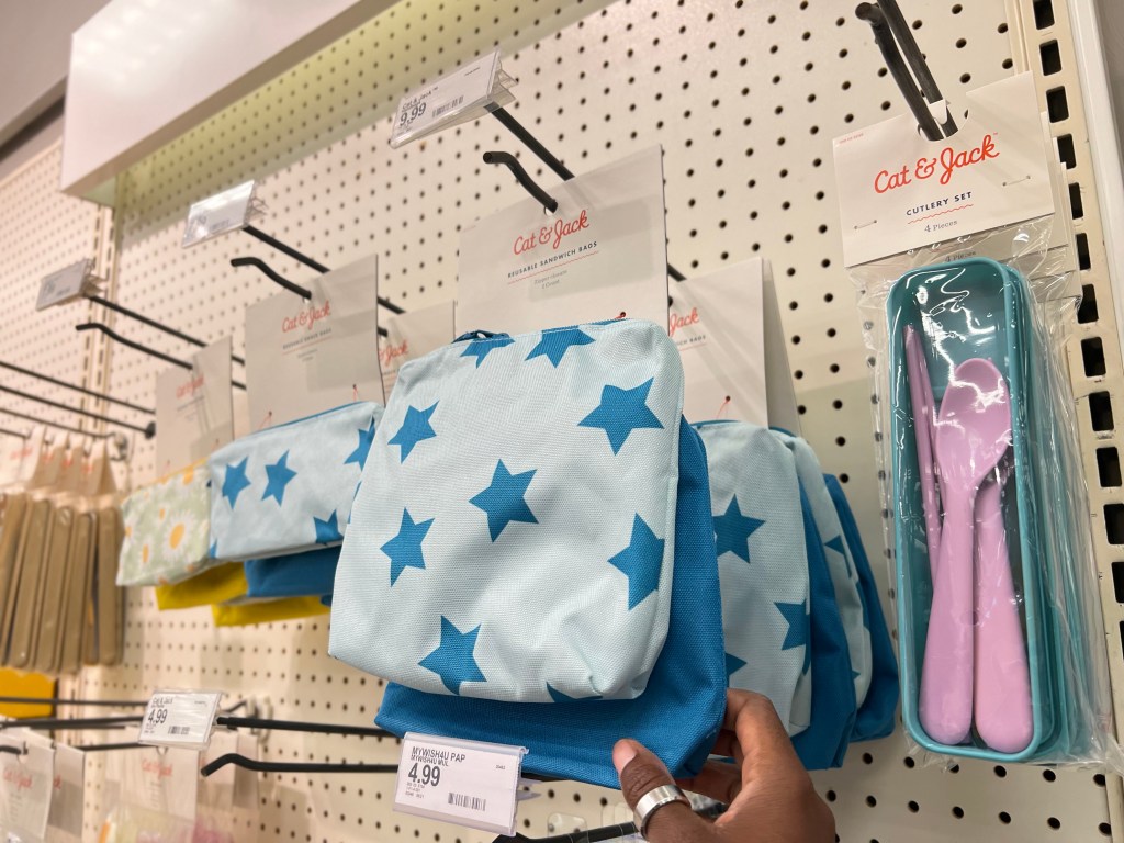 Cat & Jack 2 pk Reusable Sandwich Bags on shelf at Target with woman's hand reaching for them.