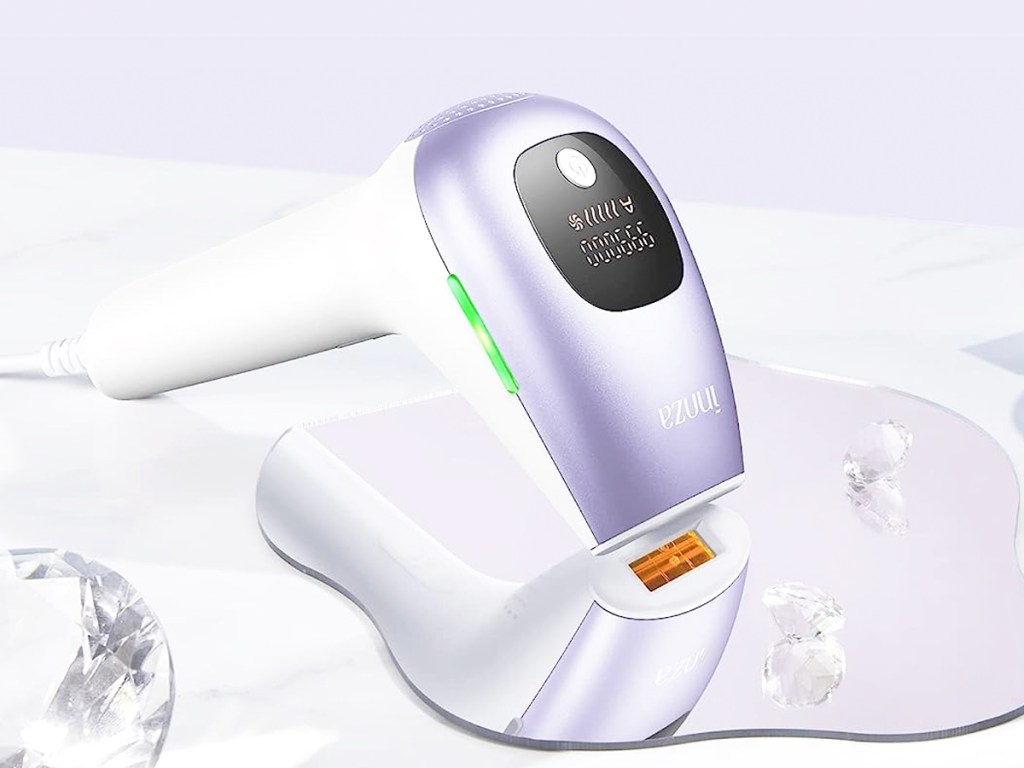 purple and white IPL device laying on a mirror