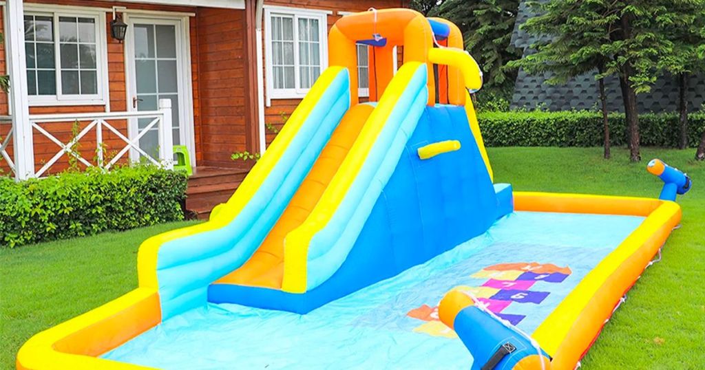 sKONYON Kids Bounce House Inflatable Water Slide set up in the front yard of a home