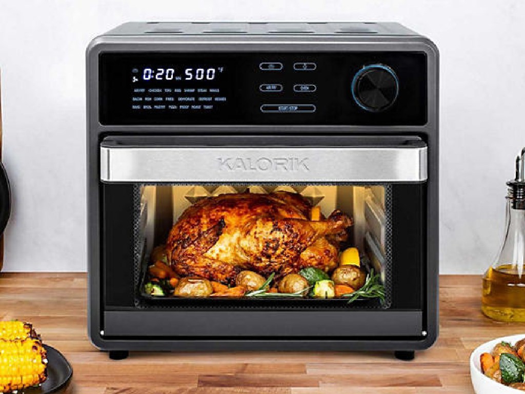 Kalorik MAXX Touch 16 Quart Air Fryer Oven sitting on counter with food around