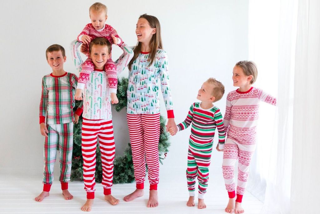 a group of 6 Kids in all different sizes from baby to kid wearing made to order christmas pjs