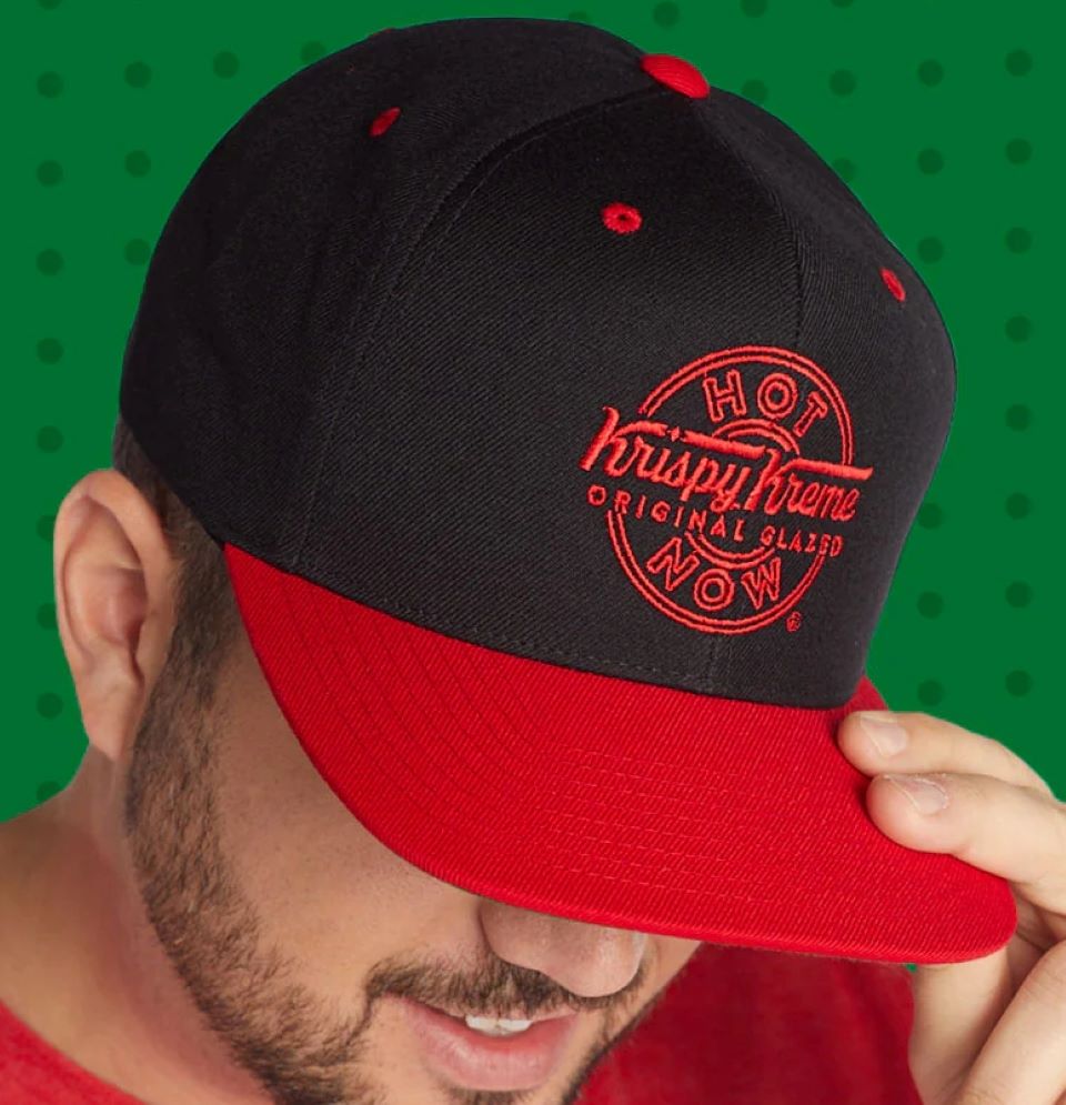 Man wearing a red and black Krispy Kreme hat