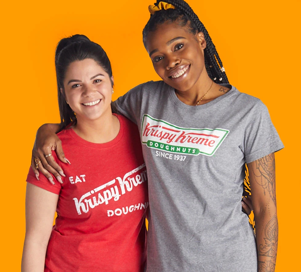 Two women wearing Krispy Kreme tees