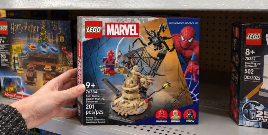 hand reaching for lego set box