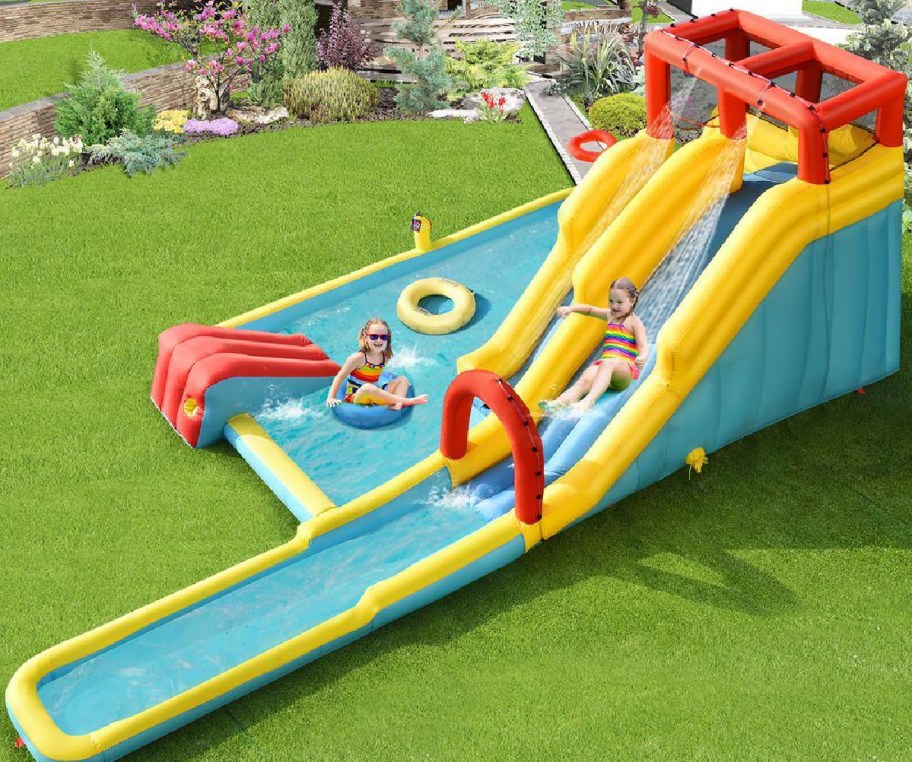 Large inflatable slide with pool on the side displayed in the backyard