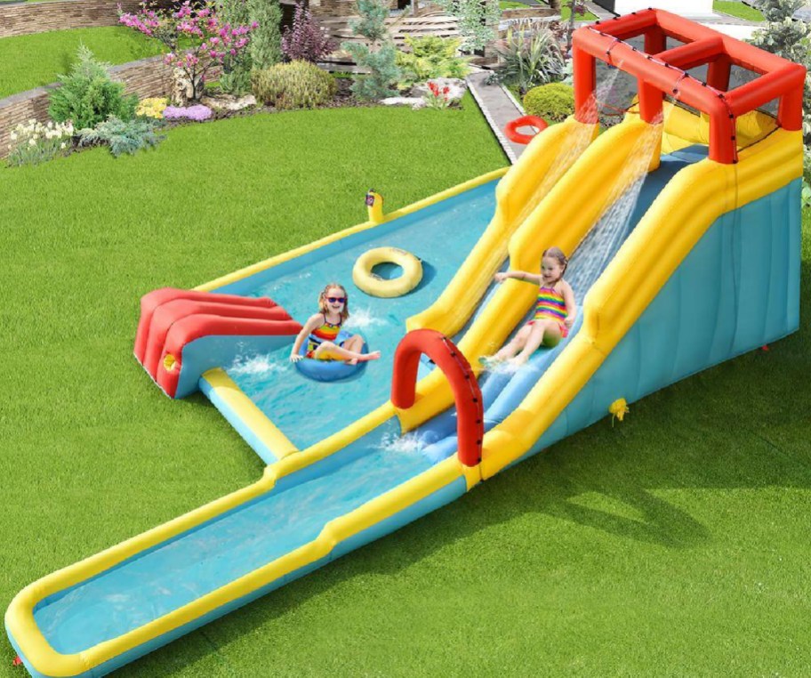 Large inflatable slide with pool on the side displayed in the backyard