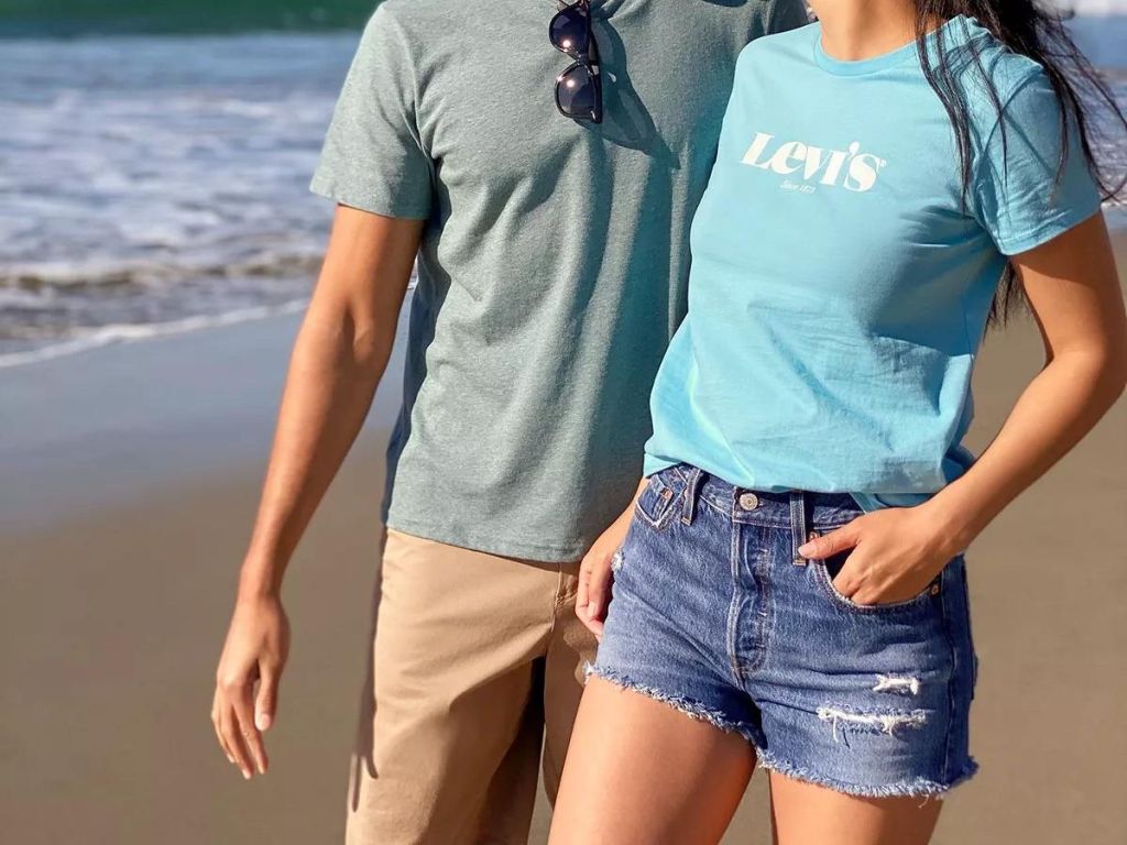 Man and a woman walking on the beach 