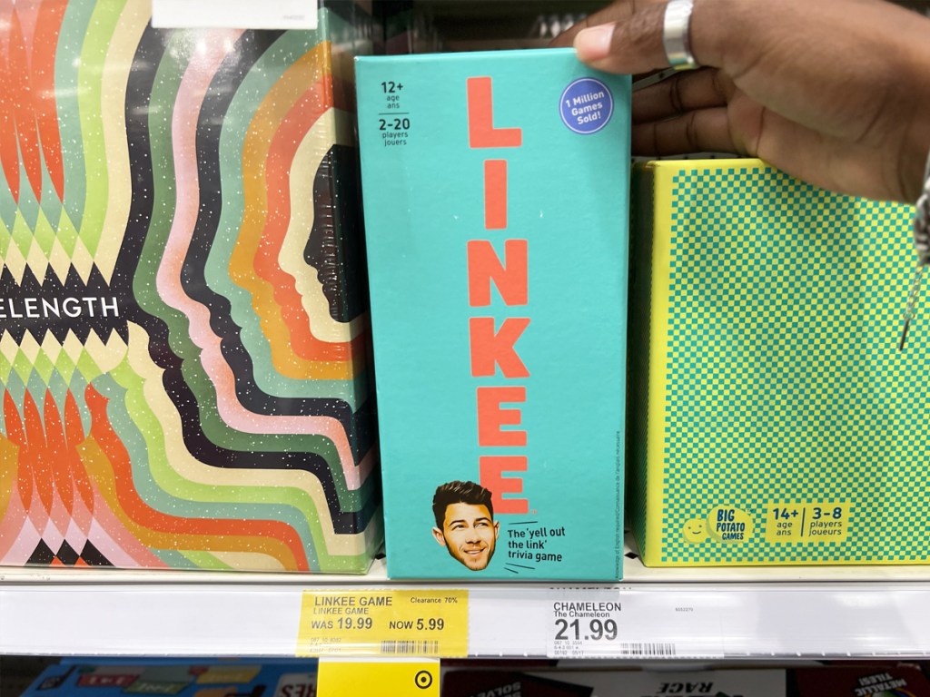 hand touching Linkee Game on store shelf