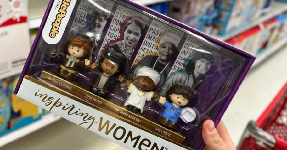 A hand grabbing a Little People Inspiring Women box off of the shelf