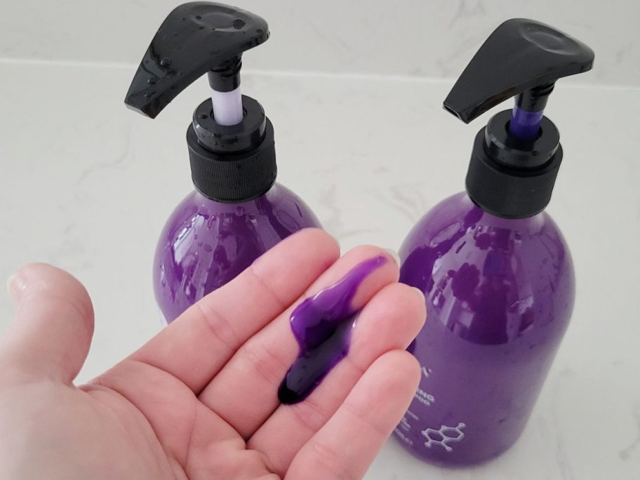 Pump of Luseta's Purple Shampoo into someone's hand