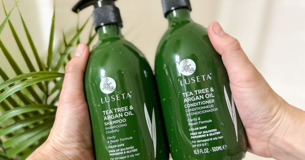 hands holding bottles of Luseta tea Tree Shampoo & Conditioner