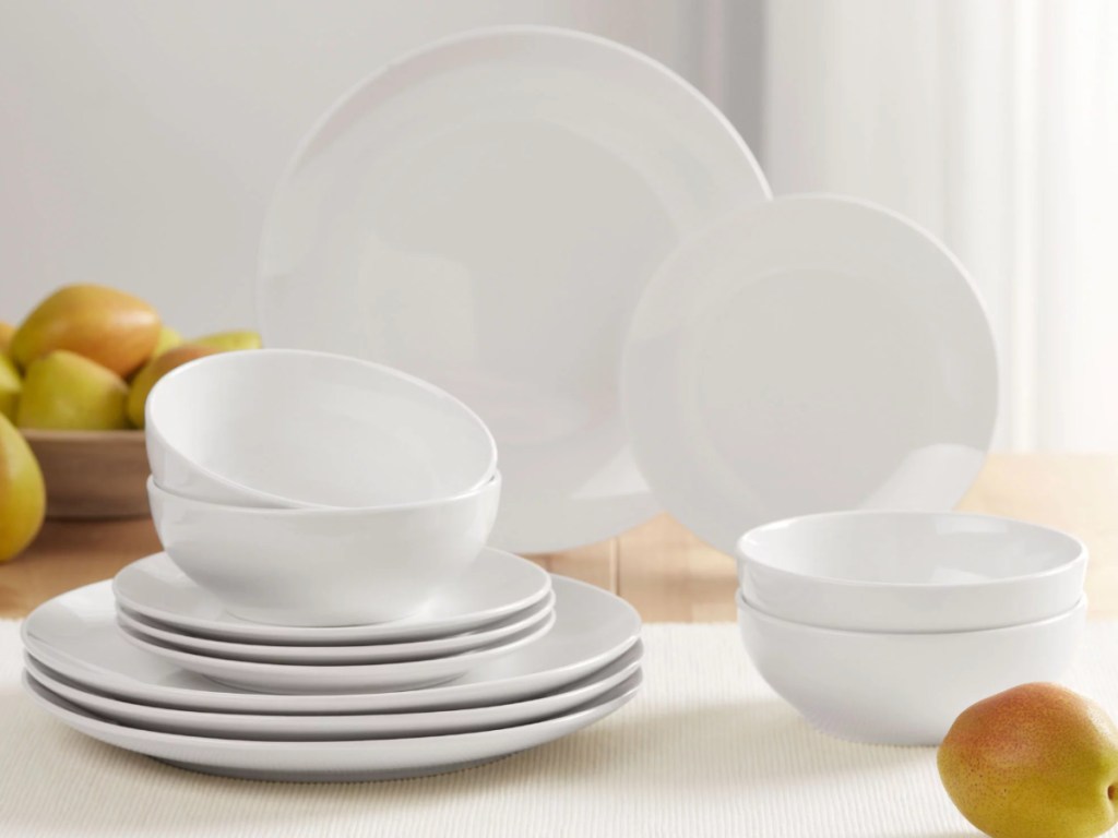white set of plates and bowls displayed on table