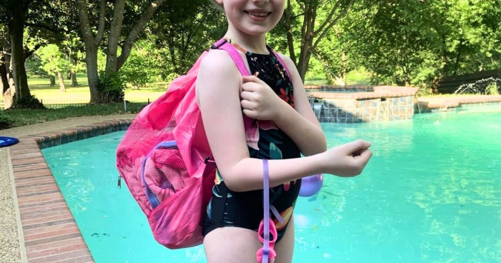 Girl by a pool wearing a Kids Mesh Swim Backpack