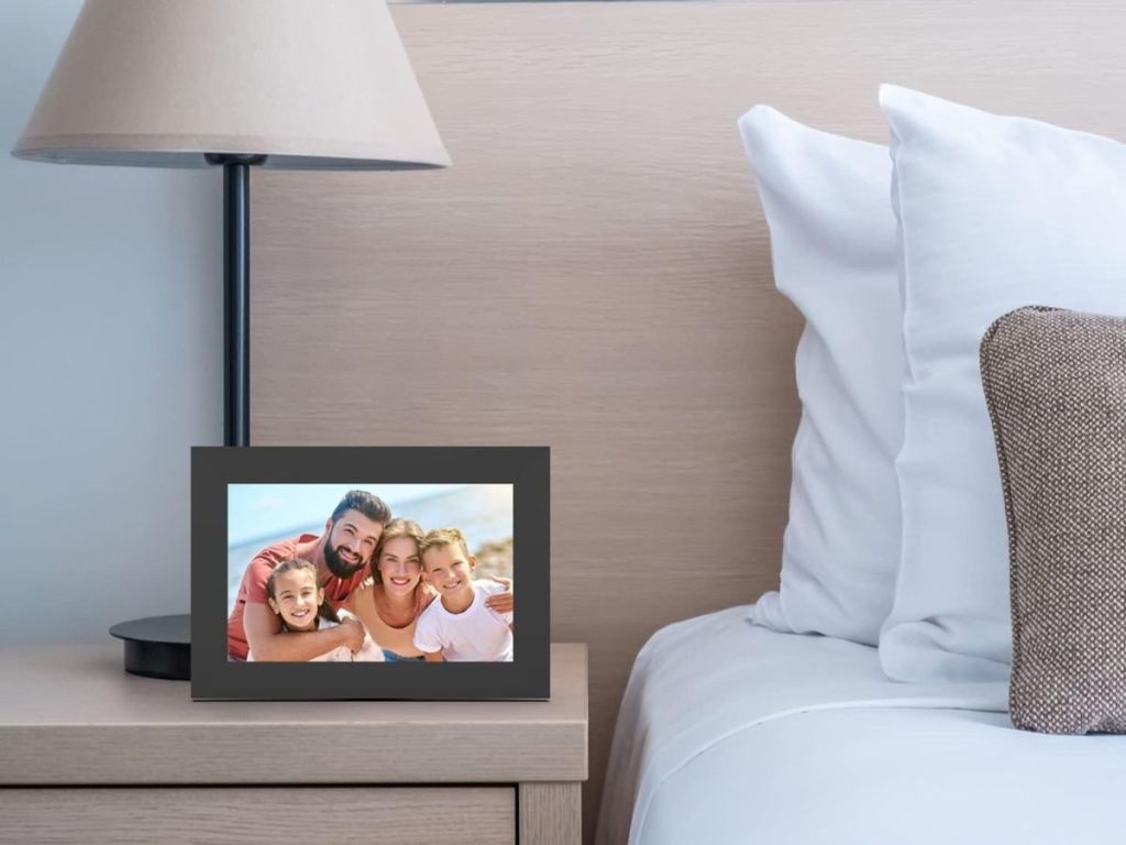 end table with lamp next to digital smart picture frame