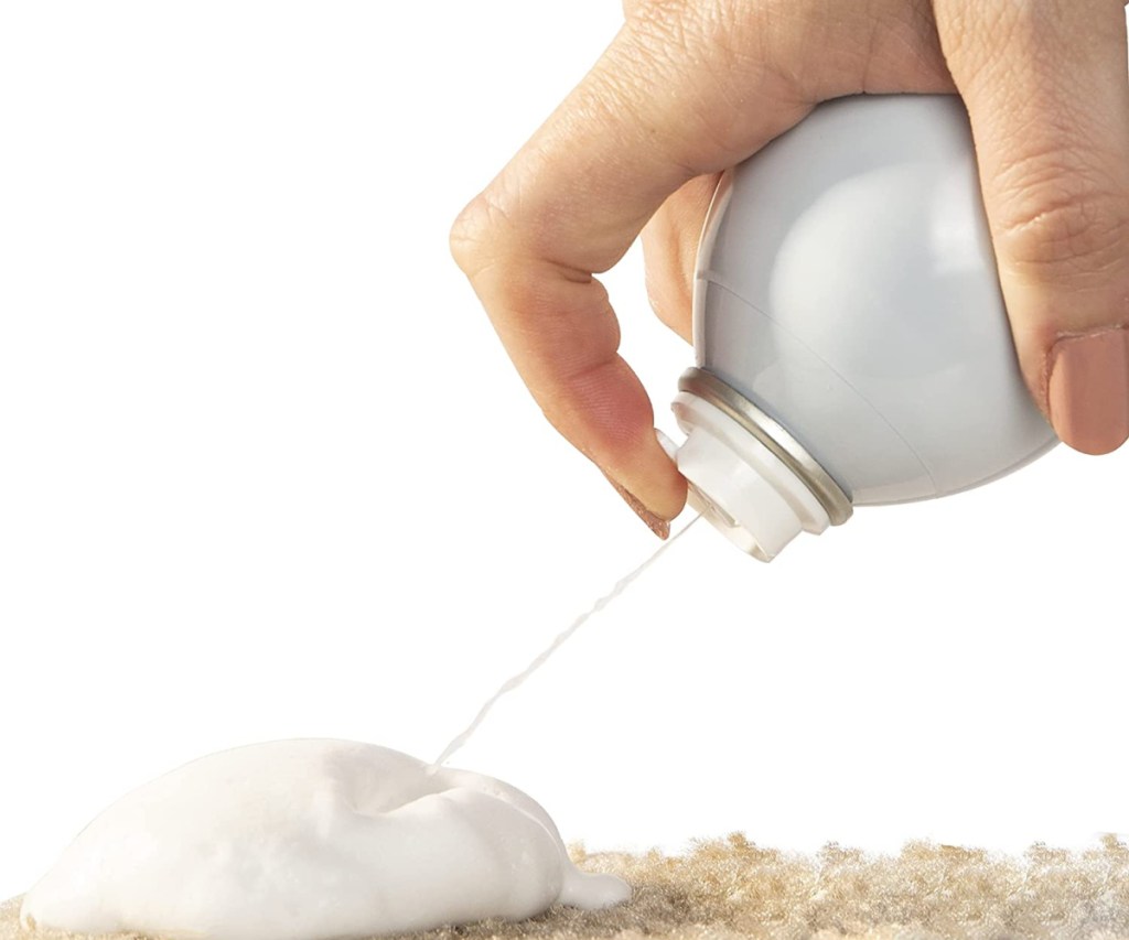 Nature's Miracle Litter Box Foam being sprayed on a carpet