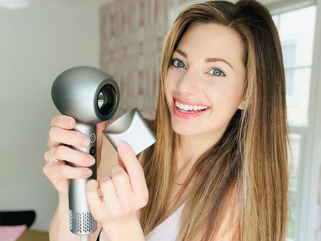 woman showing the magnetic concentrator attatchement for a Sylph hair dryer