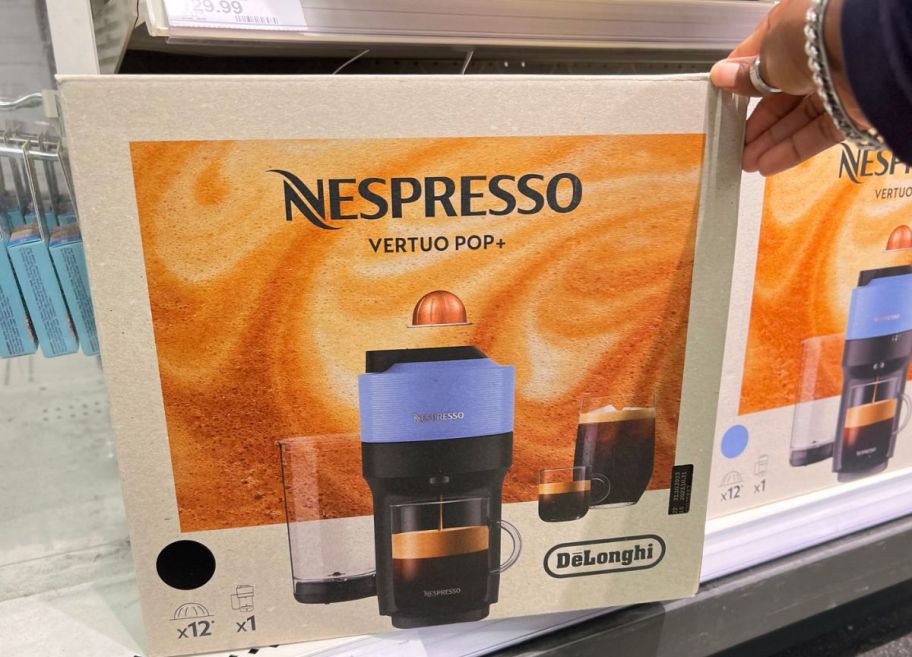 Nespresso vertuo pop plus machine in blue in the box on a store shelf