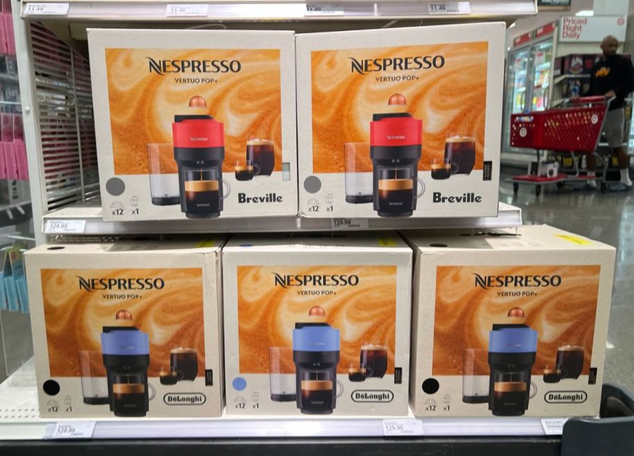 Nespresso vertuo pop plus machines on a store shelf in red and blue