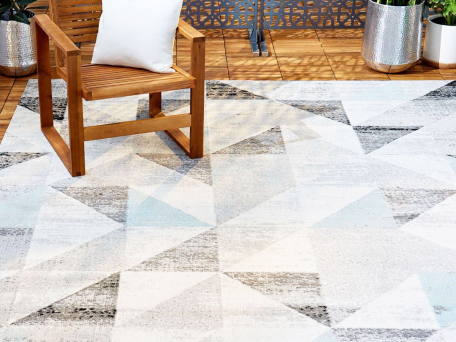 grey, white, and blue triangle print area rug