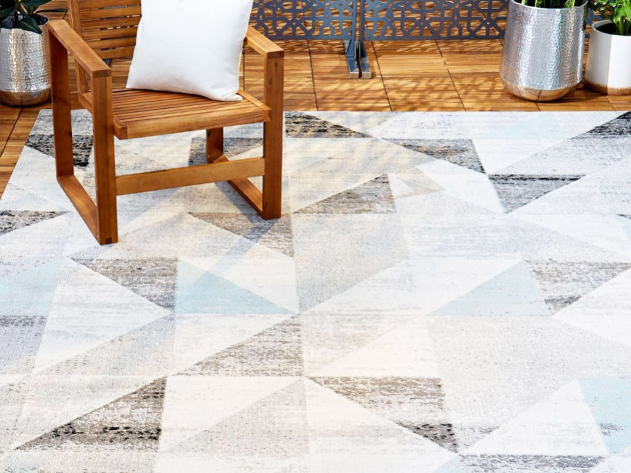 grey, white, and blue triangle print area rug