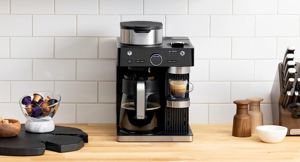 Ninja Espresso & Coffee Barista System displayed on kitchen counter with coffee pods next to it