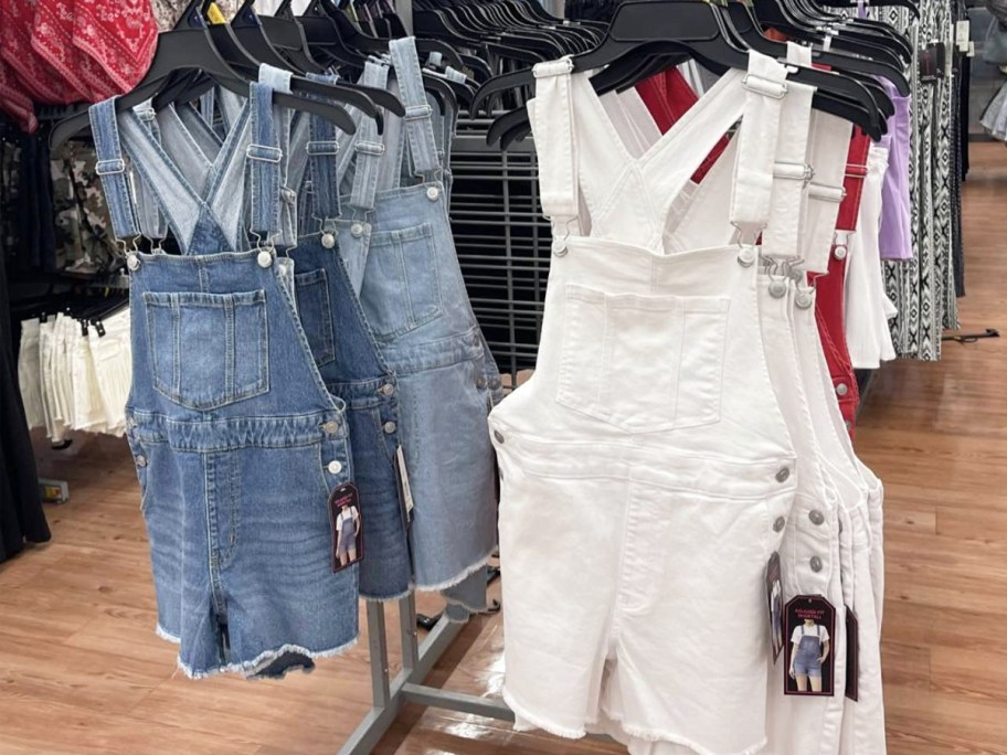 blue and white pairs of shortalls on store display rack