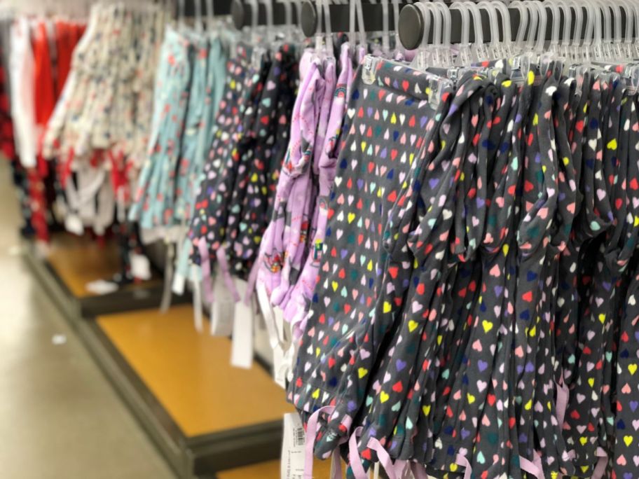 Row of girls pajamas pants on hangers at Old Navy